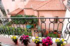 Bright sun room (covered terrace) overlooking rooftops, church towers, neighbors’ gardens and Piazza Sant’Anastasio